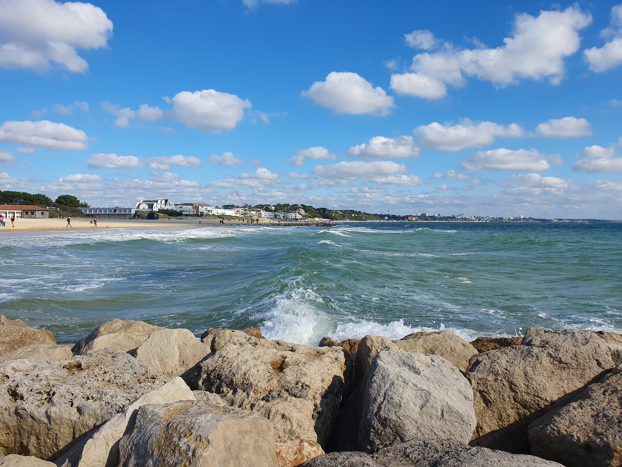 Puffy clouds on a sunny day at the beach