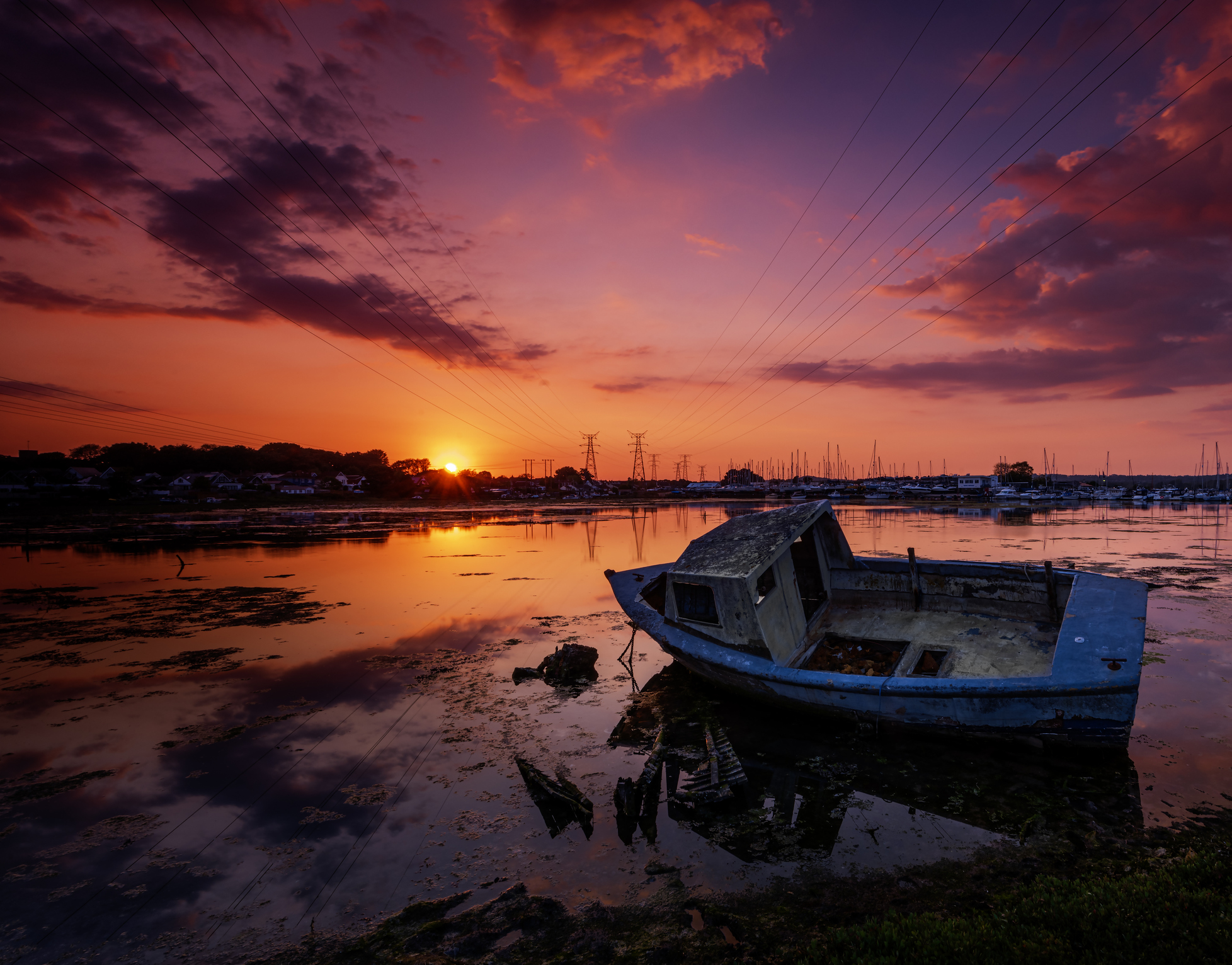 Derelict boats in the backwaters of Holes Bay, Poole Harbour at low tide romantic hotel poole